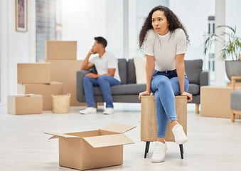 Image showing When things dont go right, go left. a young woman looking worried while unpacking boxes in her new house.