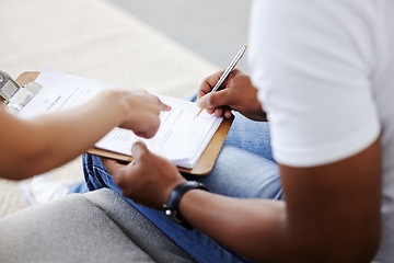 Image showing Sign here please. an unrecognisable rental agent sitting with her client and showing him where to sign the lease agreement.