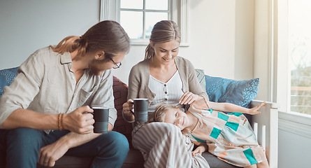 Image showing This family runs on caffeine and love. a couple drinking coffee while sitting at home with their daughter.