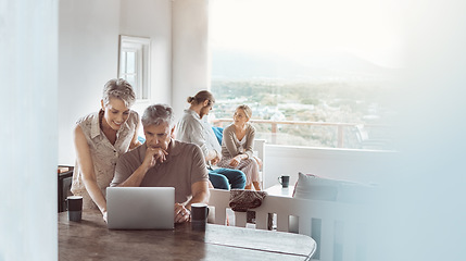 Image showing Come join us for coffee when youre done. a mature couple using a laptop at home while a young couple sits in the background.