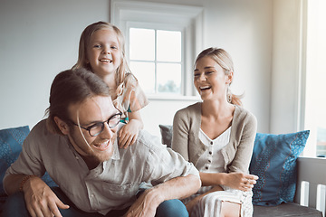 Image showing A happy family is one of lifes greatest joys. a young couple and their daughter sitting together at home.