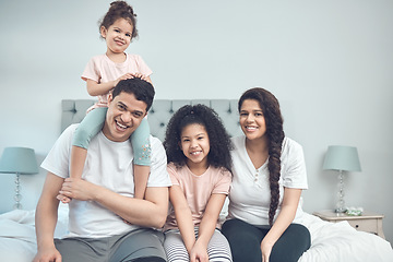 Image showing Every void filled. Portrait of a beautiful young family talking and bonding while sitting on a bed together.