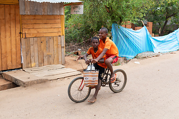 Image showing Two Malagasy boys on one bike. Mandoto, Madagascar