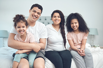 Image showing Never to be destroyed. Portrait of a beautiful young family talking and bonding while sitting on a bed together.