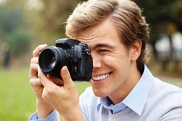 Image showing Hold that pose for me. a young man taking photos in a park.