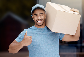 Image showing Number one in the business. Portrait of a young delivery man showing thumbs up while holding a box.