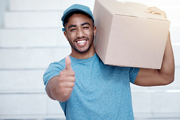 Image showing Youll be highly satisfied with our efficient service. Portrait of a young delivery man showing thumbs up while holding a box.