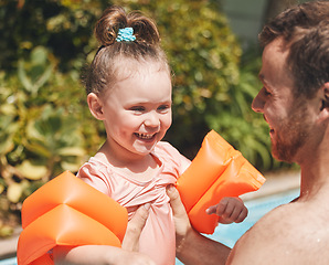 Image showing Can I let go. an adorable little learning to swim with her father.