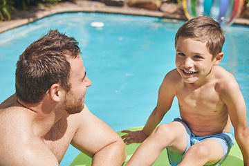 Image showing What do you wanna do today. High angle shot of a handsome young man and his son swimming outside.