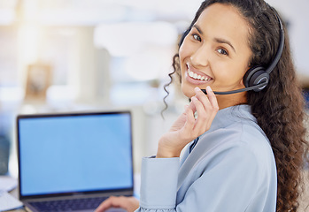 Image showing She can sell just about anything. Portrait of a young call centre agent working on a laptop in an office.