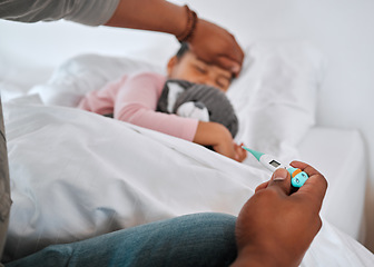 Image showing Whats her temperature. an unrecognizable parent checking a sick boys temperature at home.