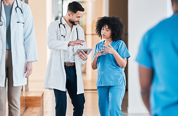 Image showing The internet knows a lot, but not as much as your doc. two young doctors using a tablet and having a discussion in a modern office.