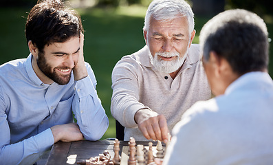 Image showing Ill teach you the ways of the world of chess. a group of men playing a game of chess outside.