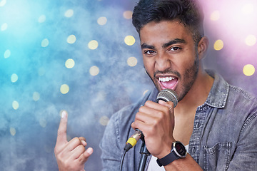 Image showing Hes so rock n roll. Cropped portrait of a handsome young male rocker singing on stage.