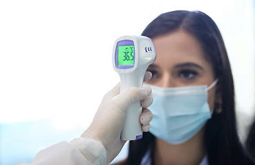 Image showing Youre good to go. a group of businesspeople standing in a line to get their temperatures read.