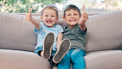 Image showing Are we having fun You bet we are. two adorable little boys showing thumbs up on the sofa at home.