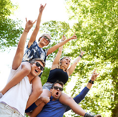 Image showing Epic times. Two guys carrying their girlfriends on their shoulders at a music festival.