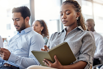 Image showing The successful knows theres always room for improvement. a woman making notes during a conference.