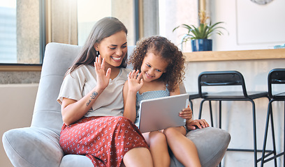 Image showing Smiling hispanic mother and funny daughter on video call using digital tablet at home. Young mother and little girl using digital tablet while making video call and waving hello