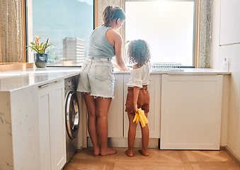 Image showing Little girl helping her mother with household chores at home. Happy mom and daughter washing dishes in the kitchen together. Kid learning to be responsible by doing tasks