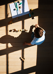 Image showing Top view of little toddler boy playing with wooden colorful building blocks sorting shapes. Child learning skills, creativity and imagination development game. Learn when play