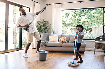 Image showing Dad and son having fun while cleaning at home. African american father and boy playing air guitar with mop and broom while cleaning living floor. Making chores fun