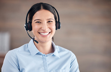 Image showing Portrait of a smiling mixed race call centre agent looking happy and positive while wearing a headset. Female customer service worker using headset and consult with clients online