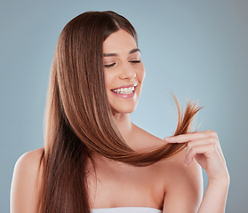 Image showing Hair is probably one of the first things you notice about people. Studio shot of a beautiful young woman showing off her long brown hair.