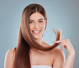 Image showing When our hair feels good you cant help but to feel good. Studio shot of a beautiful young woman showing off her long brown hair.