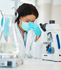 Image showing This case is proving very hard to solve. a young scientist looking stressed out while working in a lab.