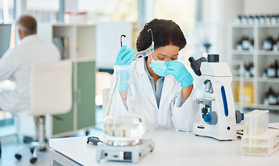 Image showing This is harder than I expected. a young scientist looking stressed out while working in a lab.