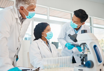 Image showing A few brilliant minds working on a breakthrough. a group of scientists working together in a lab.