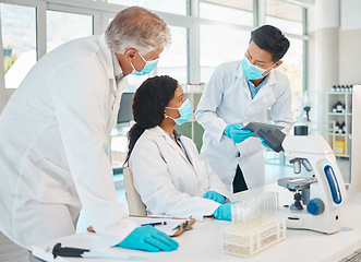 Image showing Working together to prove a new theory. a group of scientists working together in a lab.