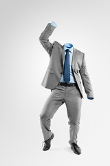 Image showing You dont need my name, you just need to dance. Studio shot of an invisible businessman dancing against a grey background.