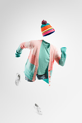 Image showing The winter wear sale is now open. Studio shot of an invisible woman running against a grey background.