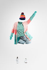 Image showing When the beat takes over. Studio shot of an invisible woman wearing winter clothing dancing against a grey background.