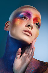 Image showing You have the power to be someones rainbow. Studio shot of a young woman posing with multi-coloured paint on her face.