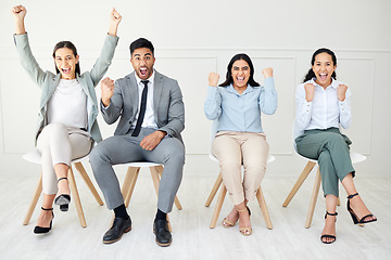 Image showing All vying for the same position. Portrait of a group of businesspeople people cheering while sitting down against a grey background.