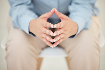 Image showing Its been weighing on his mind. Closeup shot of an unrecognizables hands while sitting nervously in the studio.