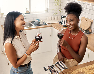 Image showing Time to wine down. two young friends drinking wine together at home.