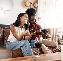 Image showing Its just friendly competition. two young friends playing games at home.