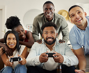 Image showing Were here to cheer you guys on. two people playing video games while sitting at home with their friends.