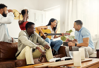 Image showing My friends are so special and so talented. a woman playing the guitar while sitting in a living room with her friends.