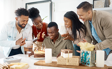 Image showing What do you do while people are singing for you. a young man celebrating his birthday with friends at home.