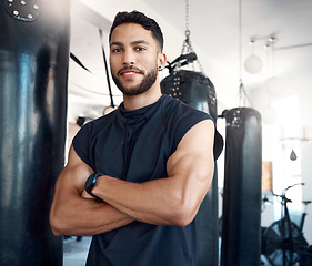 Image showing A healthy and happy body is worth the effort. Portrait of a sporty young woman standing with his arms crossed in a gym.