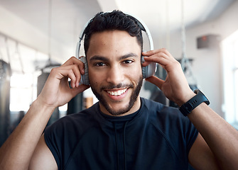 Image showing Now Im pumped. Portrait of a sporty young man listening to music while exercising in a gym.