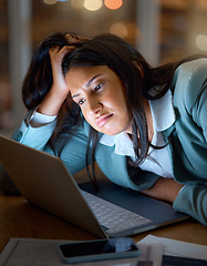 Image showing Looks like another late night. an attractive young businesswoman looking bored while working late at her company offices.