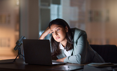 Image showing These late nights are a little too much. an attractive young businesswoman looking bored while working late at her company offices.