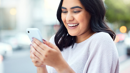 Image showing Theres nothing you cant do with the right connections. a young businesswoman using a smartphone against an urban background.