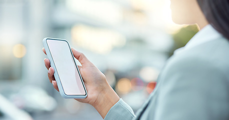 Image showing My lifeline to the business world. a businesswoman using a smartphone against an urban background.